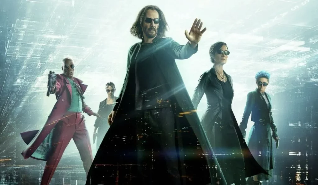 Expectativas Matrix 4: Ressurections Pôster promocional do filme Matrix 4: Ressurections. Neo à frente com Trinity e outros personagens atrás, ambientado um lugar digital com luzes brancas e azuis.