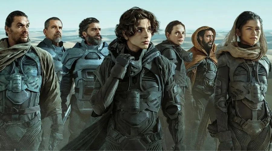Elenco Duna 2021 - Crítica Duna 2021 Seis personagens do filme Duna de 2021. 4 homens e 2 mulheres. Todos com armaduras negras e alguns com panos na cabeças.
